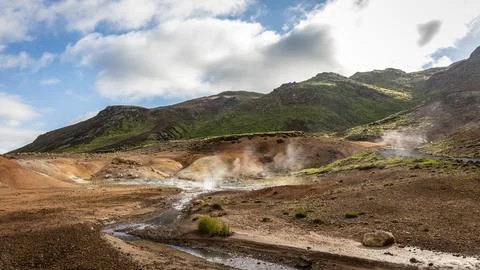 The active Krysuvik geothermal area with its brown earth, dramatic clouds, sm Stock Photos