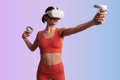 Active lady in VR glasses using controllers Stock-Fotos