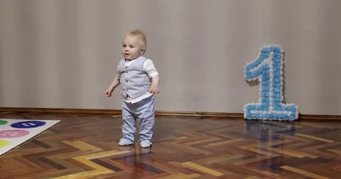An active little boy dances at home on his birthday. Stock Footage 78591976