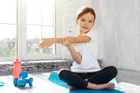 Active little child doing exercises at home Stock Photos