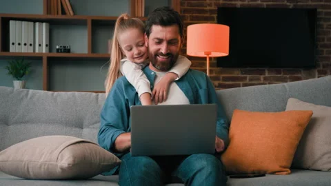 Active little child need parental attention disturb dad from working on laptop Stock Footage 217777966