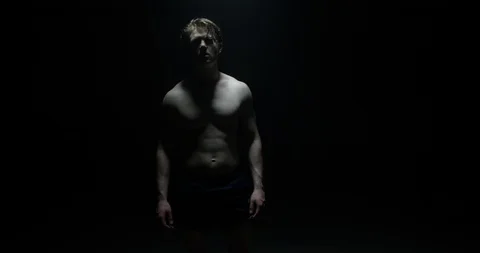 Active Male With Back To Camera Walking Into Spotlight After Training Exercis Stock Footage 113784120