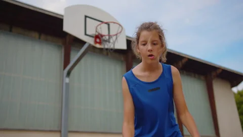 Active male basketball player practicing ball handling skill, dribbling ball Stock Footage 205836998