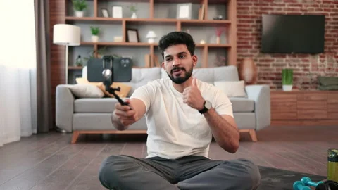 Active male making video tutorial via smartphone at home Stock Footage 236536775