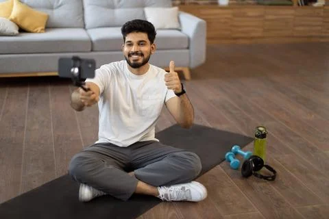 Active male making video tutorial via smartphone at home 스톡 사진