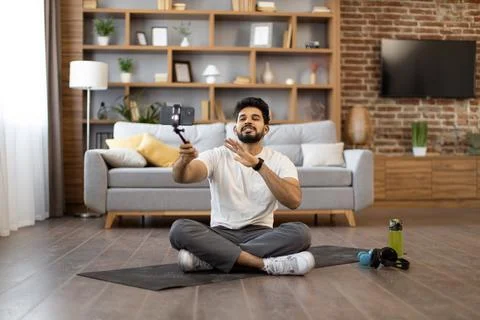Active male making video tutorial via smartphone at home Stock Photos