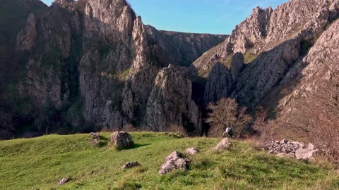 Active man with backpack hiking through the rocky meadows 스톡 동영상 224062900