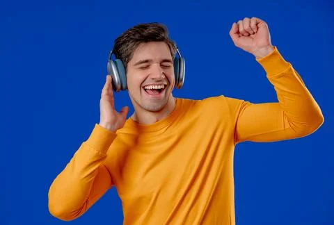 Active Man Dancing With Wireless Headphones. Relaxation, modern digital life. Stock Photos