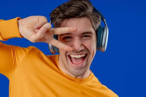 Active Man Dancing With Wireless Headphones. Relaxation, modern digital life. Stock Photos