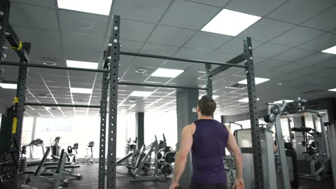 Active man doing pull ups in gym, body workout program, strong muscles training Stock Footage 88565473