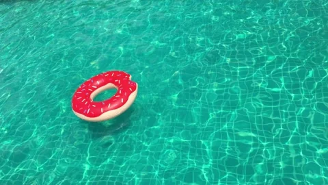 Active man jumping inside swiming pool with inflatable swim ring Stock-Footage 170783302