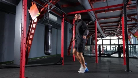 Active man jumping skipping rope in sport club. Stock Footage 259914805