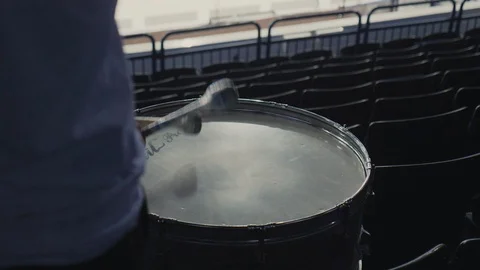 Active man plays drum with sticks at sports match on stadium Stock Footage 118768338