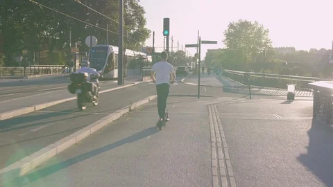 Active Man Riding on Electric Scooter in City with Tramway 2 Vidéo 112140944