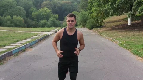 Active man run in park outdoor. Male runner jogging outdoors Stock Footage 141056742
