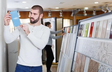 Active man standing with sample of ceramic tile Stock Photos