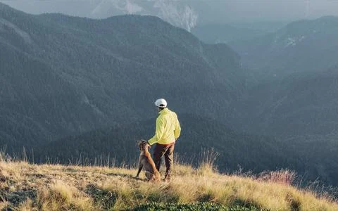 Active man walking with dog Stock-Fotos