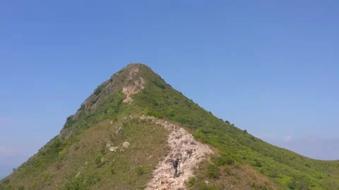 Active man walking toward the peak of Sharp peak, Sai Kung, country park Stock-Footage 164430446