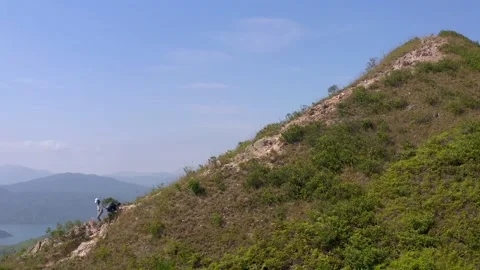 Active man walking toward the peak of Sharp peak, Sai Kung, country park Video stock 164430562