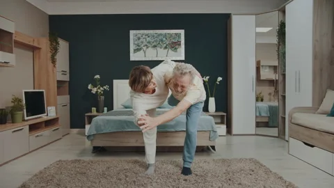 Active mature couple doing stretching exercise and and practicing yoga Vídeo Stock 327456490