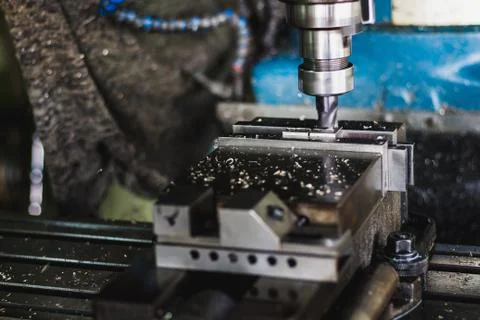 Active milling machine during processing part of engine Stock Photos