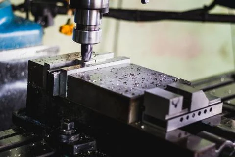 Active milling machine during processing part of engine Stock Photos