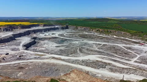 Active mining site in open pit with heavy machinery working in the area near Stock Footage 342462865