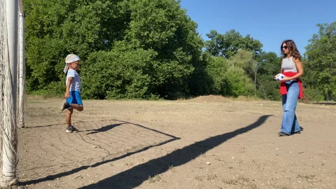 Active Mother and Son Play Friendly Soccer Game on Sunny Field Stock Footage 322121362