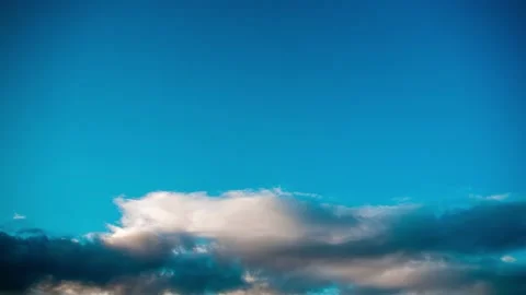 Active movement of clouds across the blue evening sky. Time lapse. Stock Footage 163409690