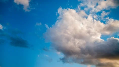 Active movement of clouds across the blue evening sky. Time lapse. Stock Footage 163759925