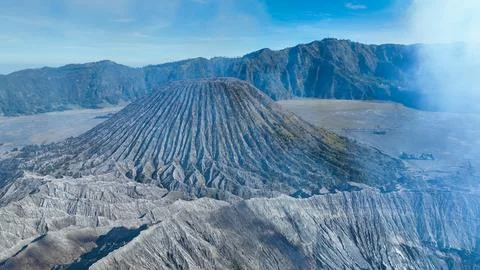 Active Mt. Bromo steaming crater anchors the Tengger Caldera, ash waves rippling Foto stock