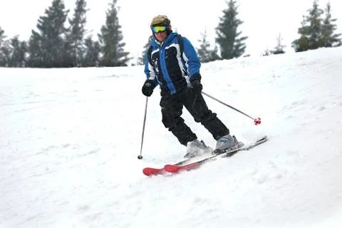 Active old aged senior experienced mature skier man in ski helmet, goggles,.. Stock Photos