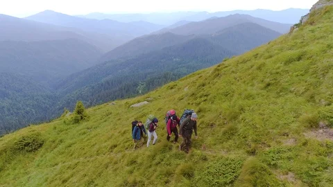 The active people with backpacks walking up on a mountain Stock-Footage 113746895