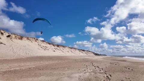 Active Person Paragliding Over Sandy Beach Stock Footage 337929027
