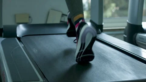 Active Pursuit: Close-Up Shot of Woman's Legs Engaged in Treadmill Workout Stock Footage 243261048