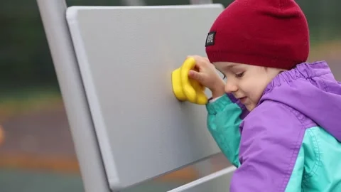 Active rest of the kid on the playground.A boy crawls on a climbing wall Stock Footage 219735243
