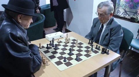 Active Retired Seniors, Two Old Men Playing Chess At old folks club Stock Footage 60236181