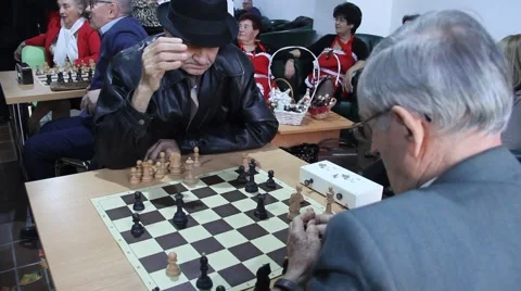 Active Retired Seniors, Two Old Men Playing Chess At old folks club Stock Footage 60236183