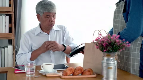 Active Senior Asian Man Using a Mobile Device for Contactless Payment Stock Footage 237082593