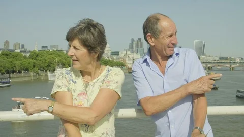 Active senior couple looking at a map in london Video stock 93627965