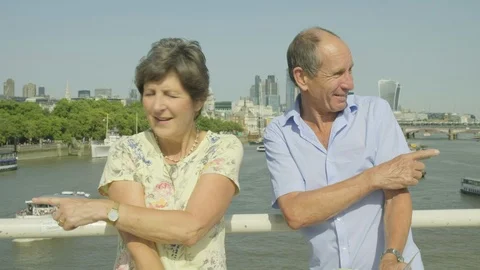 Active senior couple looking at a map in london Video stock 93628873