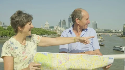 Active senior couple looking at a map in london Video stock 93629775