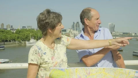 Active senior couple looking at a map in london Video stock 93631141