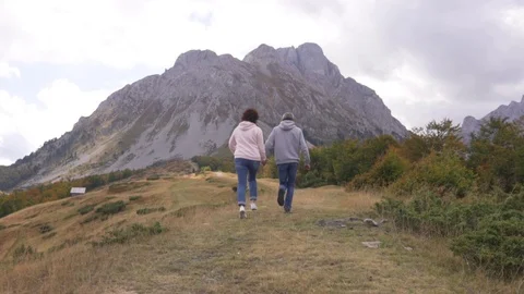 Active senior couple runing at the mountains, enjoying their adventure Stock Footage 126065448
