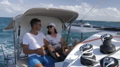 An active senior couple sailing 31 Stockbeeldmateriaal 99333601