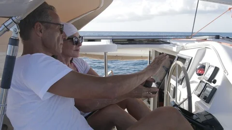 An active senior couple sailing 52 Stockbeeldmateriaal 99337955