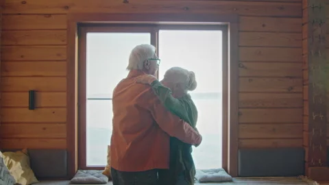 Active Senior Couple Slow Dancing in front of Bright Window Stock Footage 282377111