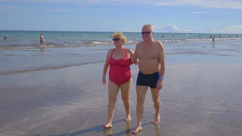 Active Senior Couple walking On The Beach in slow motion 180fps Stock Footage 159706035