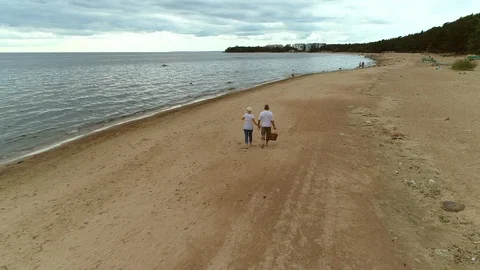 Active senior couple walking through beach together. Video stock 101791422