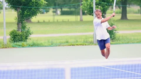 Active Senior Japanese Man Playing Tennis on Outdoor Court Stock-Footage 344032498